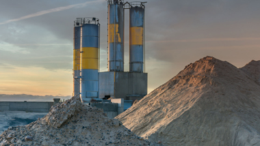 Fine bulk material in front of industrial silos