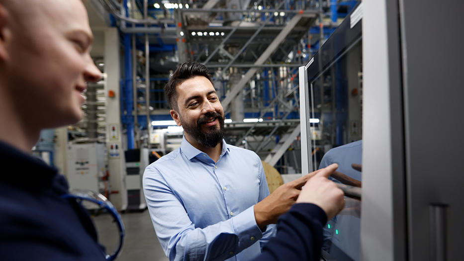 Coperion employees in front of control system at test lab